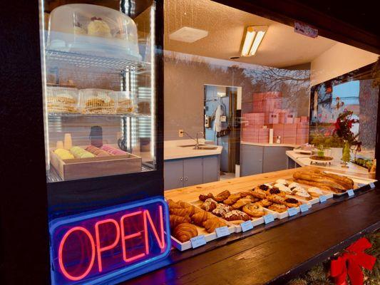 Fresh croissants and pastries displayed at our Raspberry Cake window.
