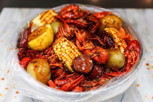 Crawfish add sausage, corn & potatoes