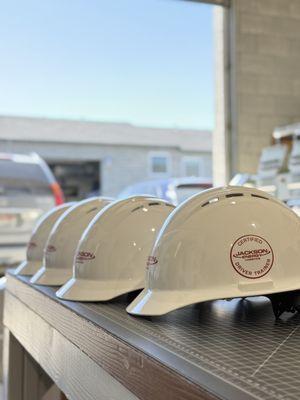 Custom hard hats with company logo printed on them.