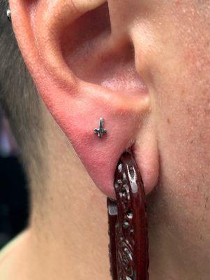 Cross lobe piercing.