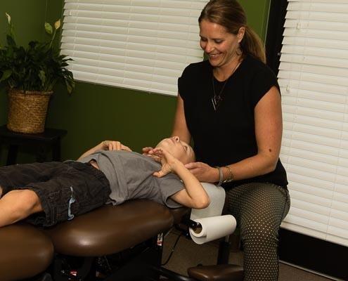 Dr. Zock adjusting a young man's neck