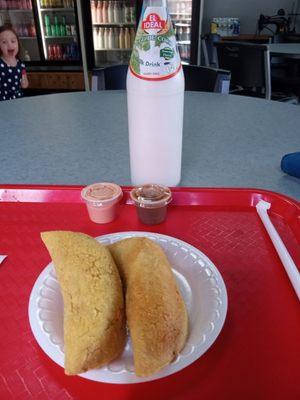 Empanadas and coconut milk drink.