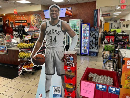 A life-size Giannis Antentokuompo greets customers for the TA Epic Dunk Sweepstakes. He is 6-foot-11.