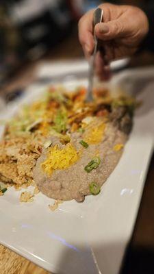 Not a clear photo. Stacked beef enchiladas, spicy rice and beans.. a drizzle of sour cream and salsa would be great..my husband loved this!