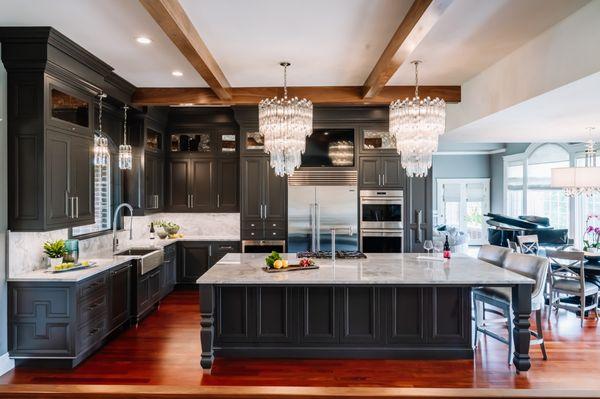 This kitchen features bold cabinets, luxe lighting, and sleek countertops - stylish focal points visible from every part of the house.