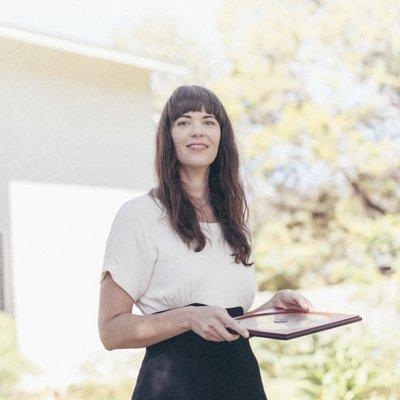 Taking a compass reading in front of a residential property. Photo by Dustin Cohen.