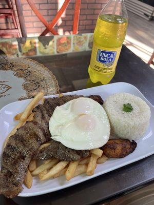 Tasty steak, fried eggs, rice and French fried platter