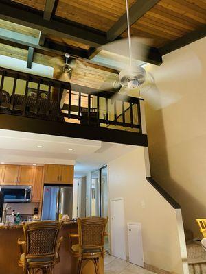 View from balcony into condo, kitchen (high end appliances) and stairs to loft. Beautiful vaulted ceiling and plenty of AC.