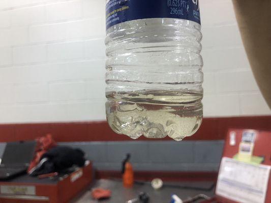 Zoom in to see debris after dealership extracted gas from my fuel tank. Water and debris in the fuel. Regular gas pumped at Pump #2