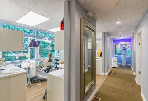 our CBCT scan at the end of the hall and clinical operatory on the left facing a private garden view.