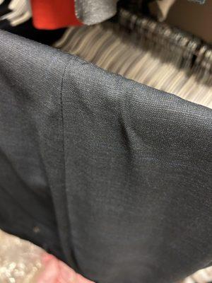 Pants folded over on the hanger in a manner that made a couple of wrinkles