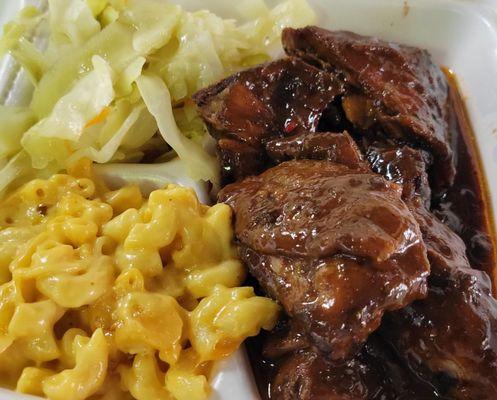 Jerk chicken with mac & cheese and cabbage. $12.