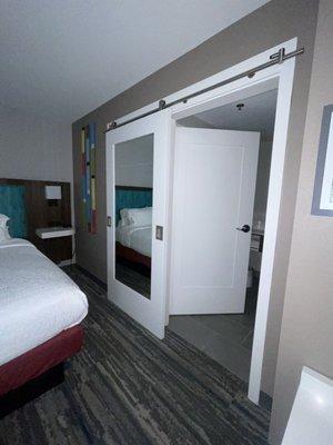 Barn door separates the bathroom.