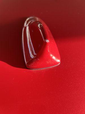 Major paint chip on antenna upon inspecting paint job during pick up.