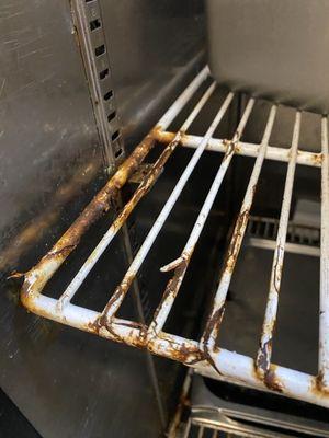 Peeling coating on cooler rack poses high risks for physical contamination. Owners made aware of this