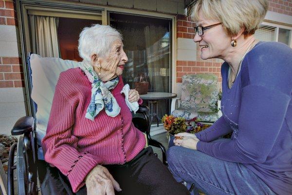 Hospice volunteer visiting Mildred on the back porch.