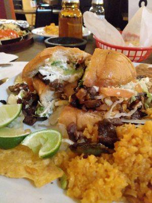 Trying out their steak torta with beans and rice. First bites are delicious!!