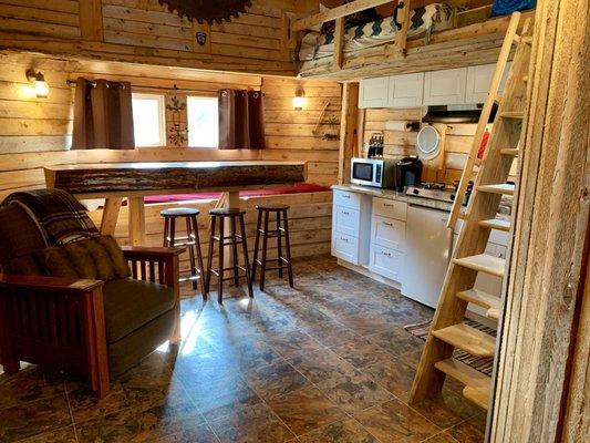 Open living area w/kitchen. Moveable stairs to loft.
