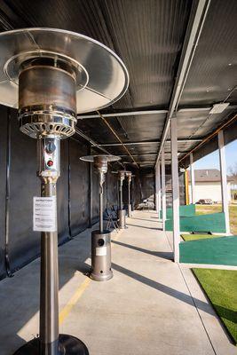 Patio heaters in the covered driving range bays.