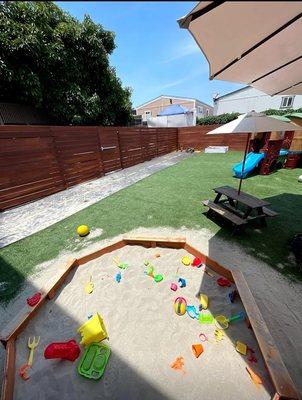 Our outdoor sandbox encourages sensory play, imagination, and cooperative fun in a fully fenced, secure environment.