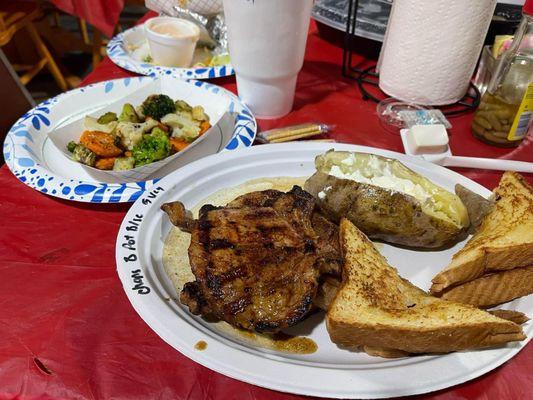 Pork chops with baked potatoes and grilled vegetables