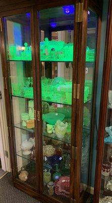 Black light shows the uranium content of the old glass pieces.