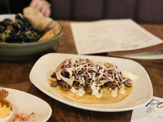 Brisket Taco with Serrano crema and white cheddar.