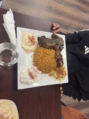 Lamb chops comes with rice, hummus and side salads.