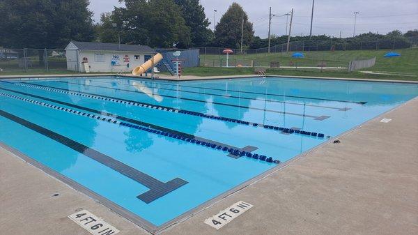 Separate wading pool at top in fenced in area, (center of photo), by red mushroom shower.