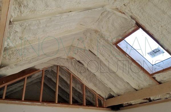 Spray foam insulation of the attic in the cottage near the lake.