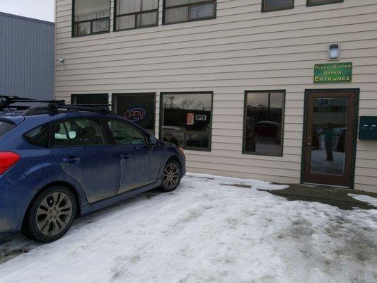 It is not Fleck Guitar Repair.