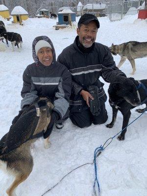 People and dogs, dog houses and a little snow. Not much.
