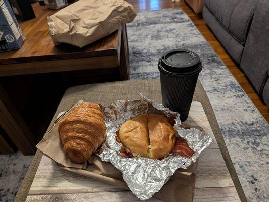 Chocolate croissant, breakfast sandwich and coffee