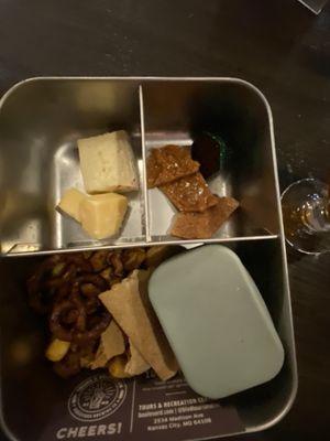 Bento box of snacks with happy hour tasting