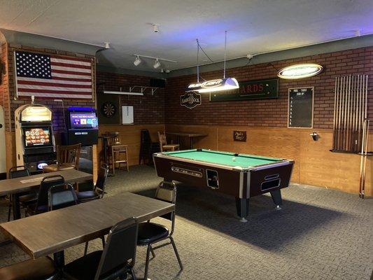 A nice pool table and dart board