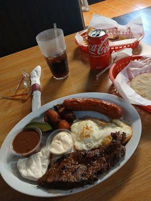 El desayuno dish with steak, fried eggs, chorizo, maduros, avocado, refried beans, a tortilla, sour cream and Salvadorian cheese mmmm!