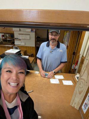 Alexander is helping me at the post office to hand stamp my postcards