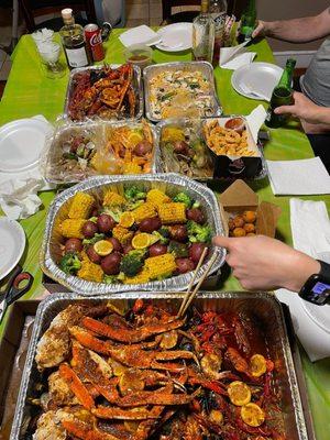 king crab legs, snow crab legs, mussels, crawfish, shrimp, clams, calamari rings, hushpuppies, corn, broccoli, potatoes & sausages