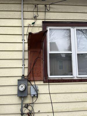Before - old wiring pulled off house and unused wiring from old phone and coax.