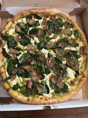 Ricotta Pesto Garlic Pizza with spinach and sausage. So good.