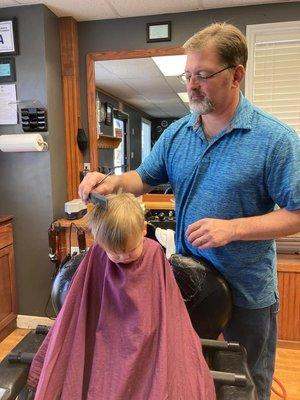 Brady getting his hair cut.