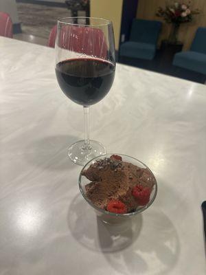 Decadent chocolate mousse and a glass of red wine.