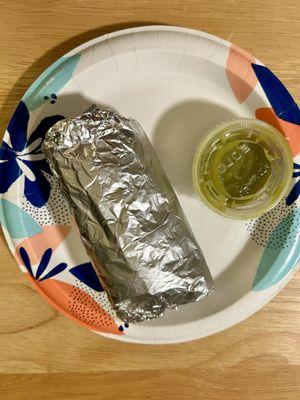 Wrapped half-portion of specialty vegetarian burrito with authentic Mexican medium green sauce