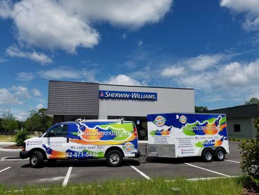 Fullcolorpainting's vibrant, branded van and trailer proudly parked at Sherwin-Williams, ready to deliver top-tier, professional painting se