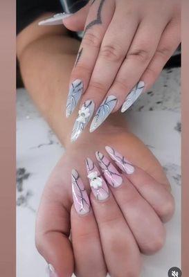 Acrylic nails art with chrome and germs. Airbrush