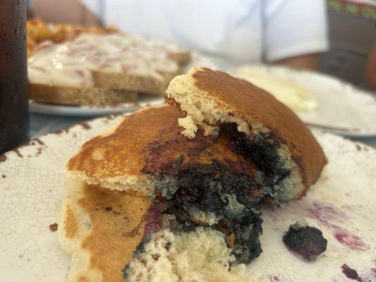 Partially eaten blueberry pancakes. We couldn't wait.