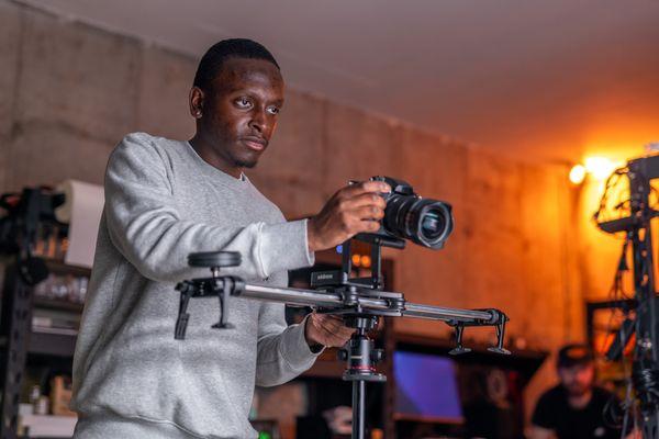 Photographer setting up a camera for a product shoot and video production session