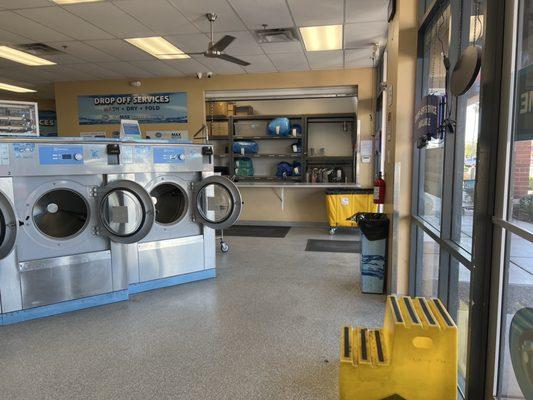 Inside by front doors looking towards the service desk. They offer a full service laundry service with folding.