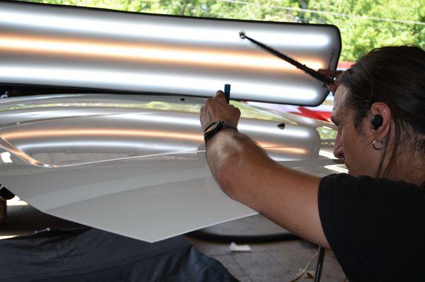 we gently use metal rods to massage the metal panel or glued suction cups  until the dent will disappear.