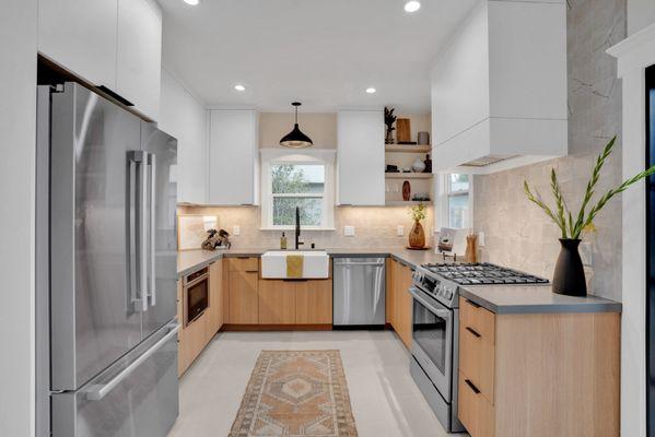 kitchen with white oak flat panel cabinets, floating shelves,concrete countertops, and area rug